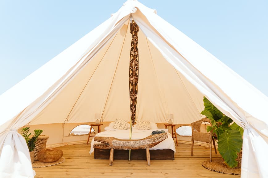 Interior of a glamping tent at Dreamsea Portugal Alentejo with double bed and boho decor