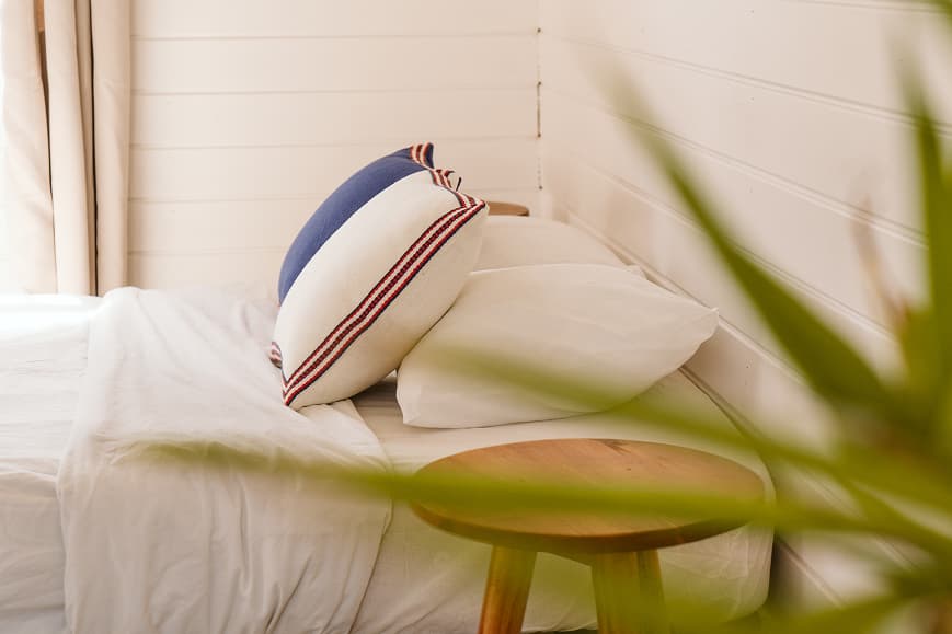 Cozy bungalow bedroom at Dreamsea Portugal Alentejo with white bedding and natural details