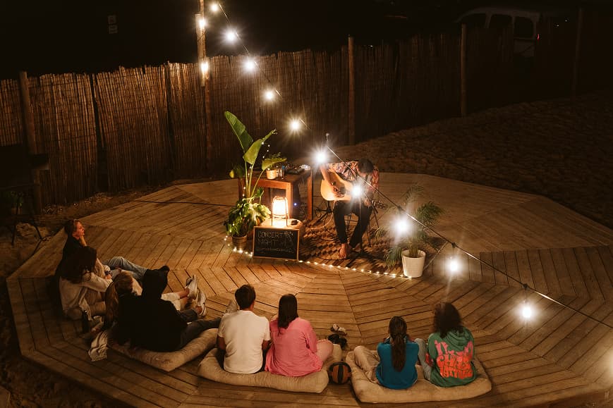 Acoustic concert night with guests gathered on cushions at Dreamsea Portugal Centro