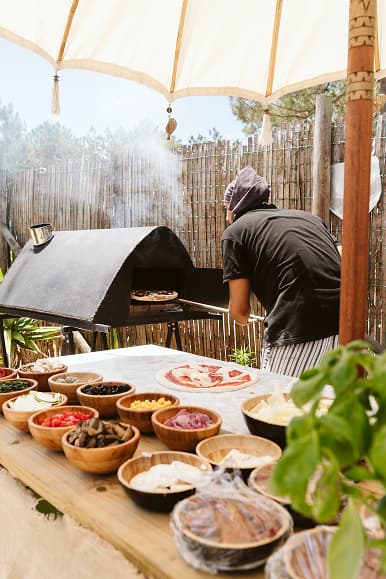 Outdoor pizza night with fresh ingredients and wood-fired oven at Dreamsea Portugal Centro