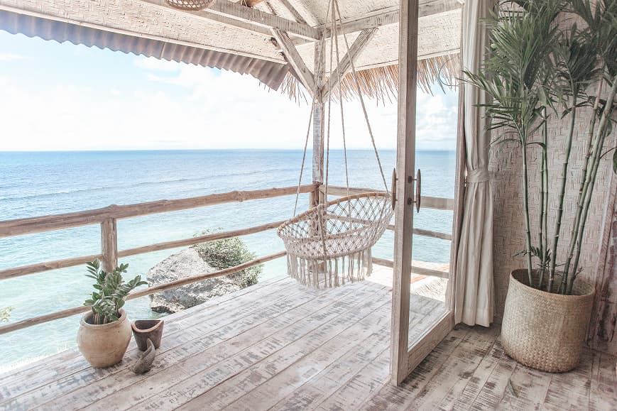 Oceanfront terrace at Dreamsea Bali Uluwatu with hanging chair and sea views