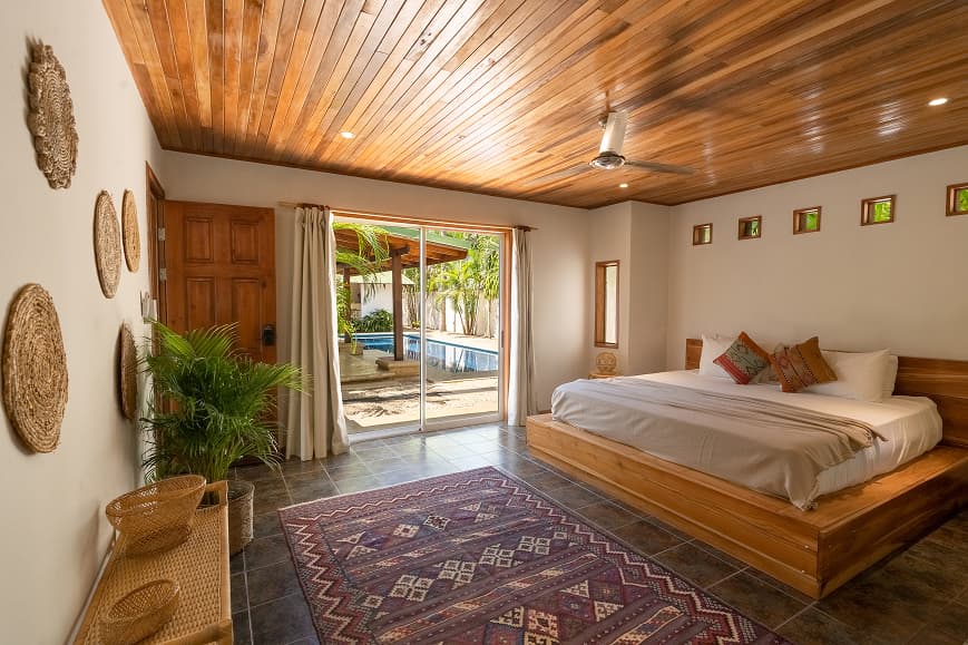 Spacious private room at Dreamsea Costa Rica Avellanas with wooden ceiling and pool view