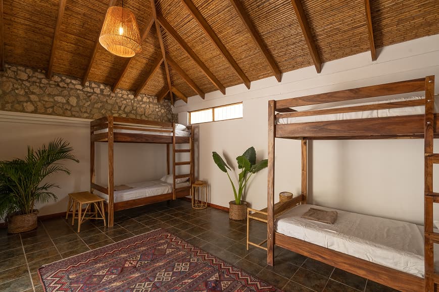 Shared dorm room at Dreamsea Costa Rica Avellanas with wooden bunk beds