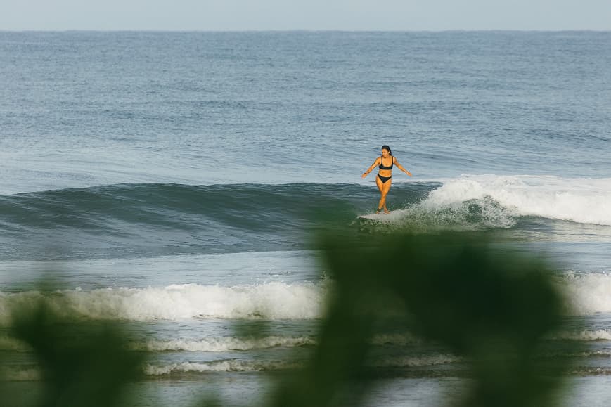 Surfer riding a smooth wave at Playa Avellanas Costa Rica