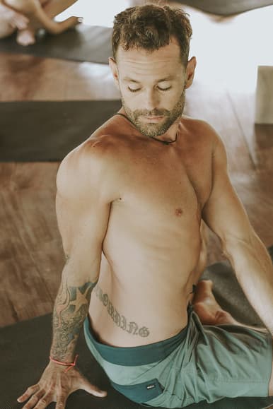 Guest practicing seated yoga twist at Dreamsea Santa Teresa
