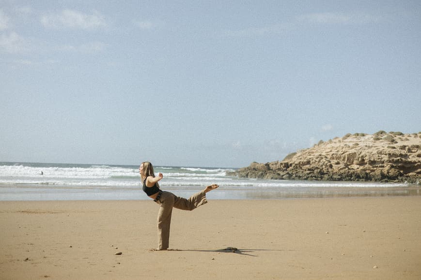 Guest practicing yoga on the beach in Imsouane Morocco