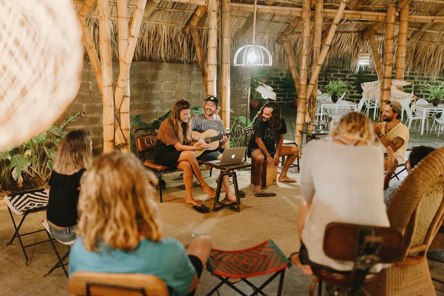 Guests enjoying live music in the bamboo common area at Dreamsea Nicaragua