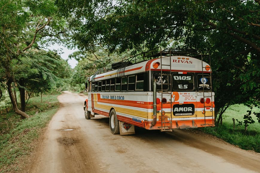 Local bus driving along a rural road in Nicaragua