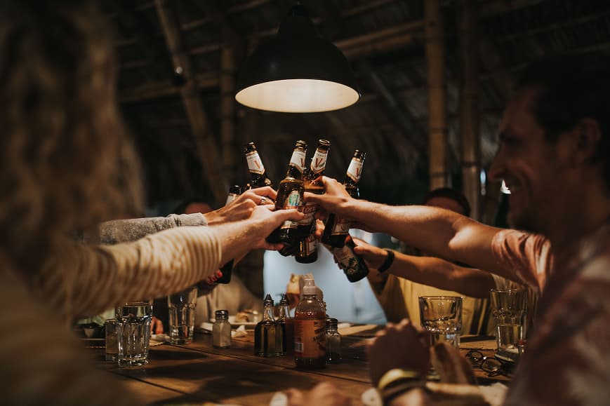 Guests sharing drinks during a group dinner at Dreamsea Nicaragua