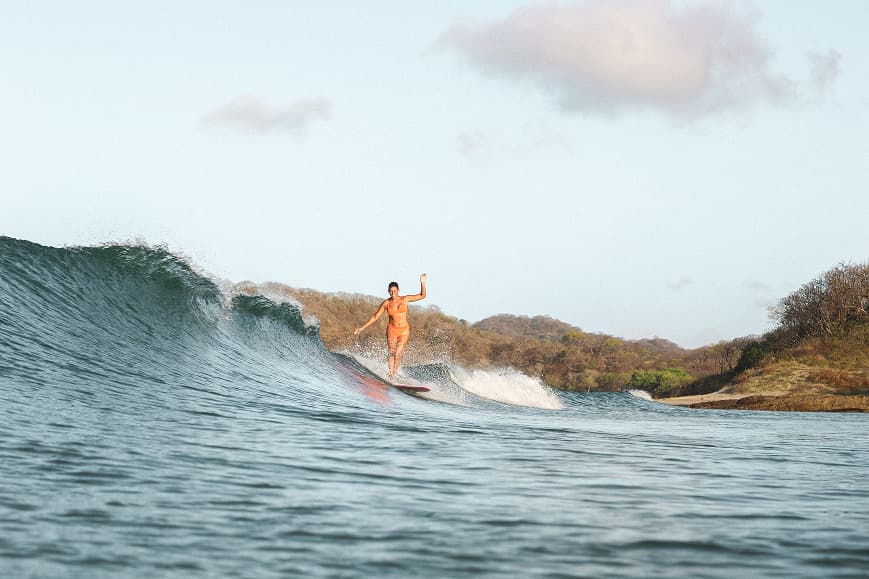 Surfer riding a clean wave on a longboard near San Juan del Sur Nicaragua