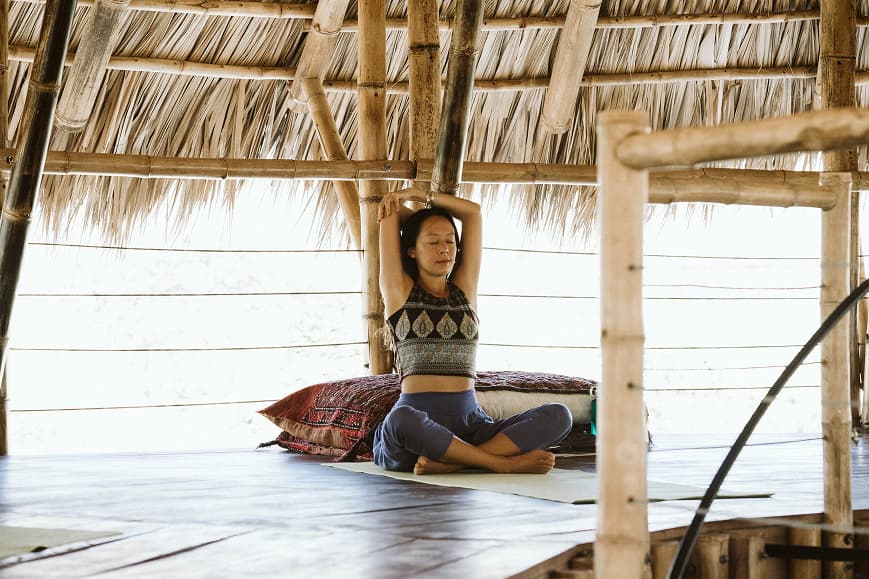 Guest practicing seated yoga in the bamboo shala at Dreamsea Nicaragua