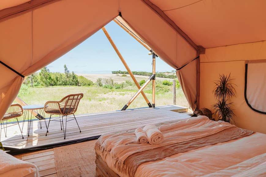 Interior of a safari glamping tent at Dreamsea Portugal Sintra with bed and countryside views