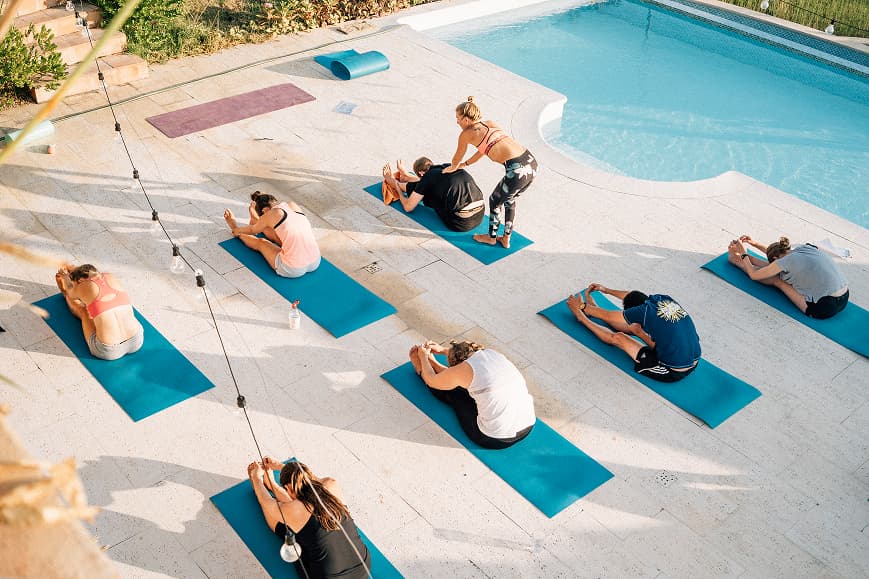 Yoga class stretching beside the pool at Dreamsea Portugal Sintra