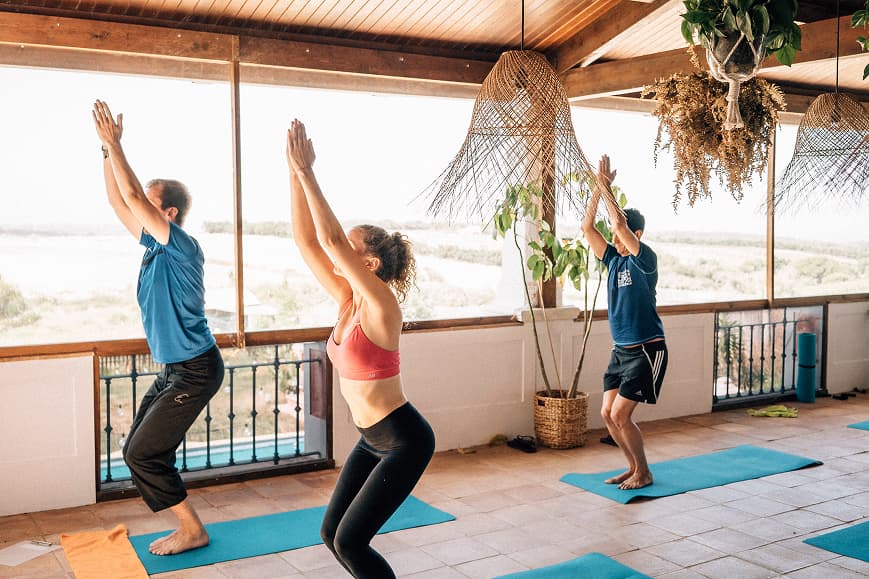 Guests practicing chair pose during a yoga class at Dreamsea Portugal Sintra