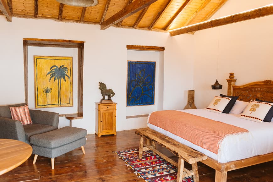 Spacious boutique bedroom at Dreamsea Gran Canaria with wooden ceiling and warm decor