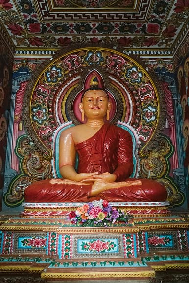 Colorful Buddha statue inside a Sri Lankan temple