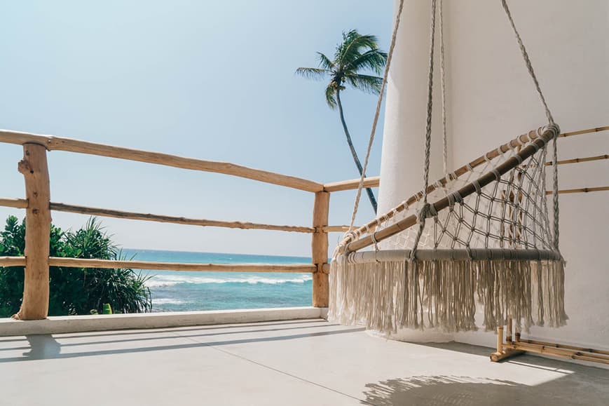 Ocean-view terrace at Dreamsea Sri Lanka Ahangama with hanging chair and palm trees