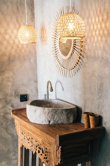 Bathroom vanity at Dreamsea Sri Lanka Ahangama with stone sink, rattan mirror and woven lamps