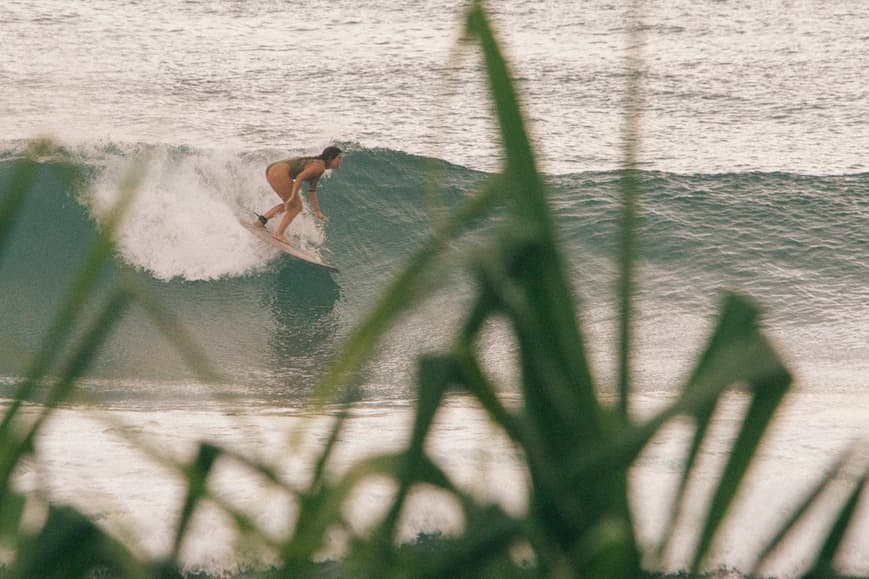 Surfer riding a clean tropical wave near Ahangama Sri Lanka