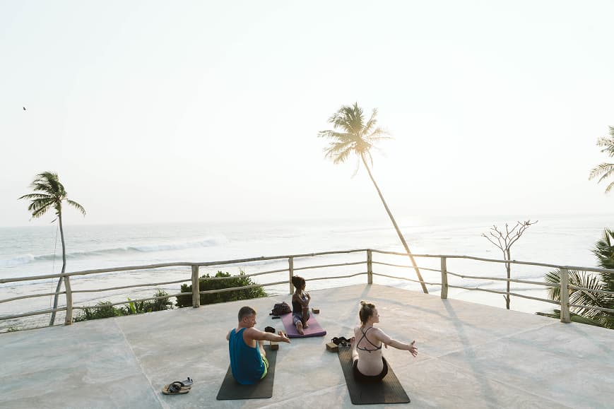 Outdoor yoga class on a terrace overlooking the ocean in Ahangama Sri Lanka