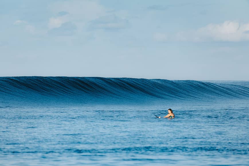 Surfer riding a clean wave in Lombok