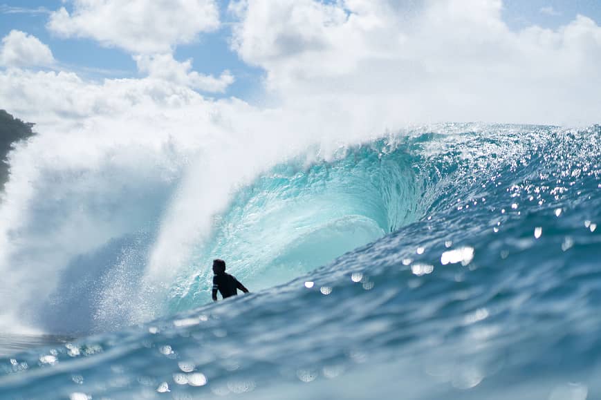 Surfer riding a clean wave in Lombok